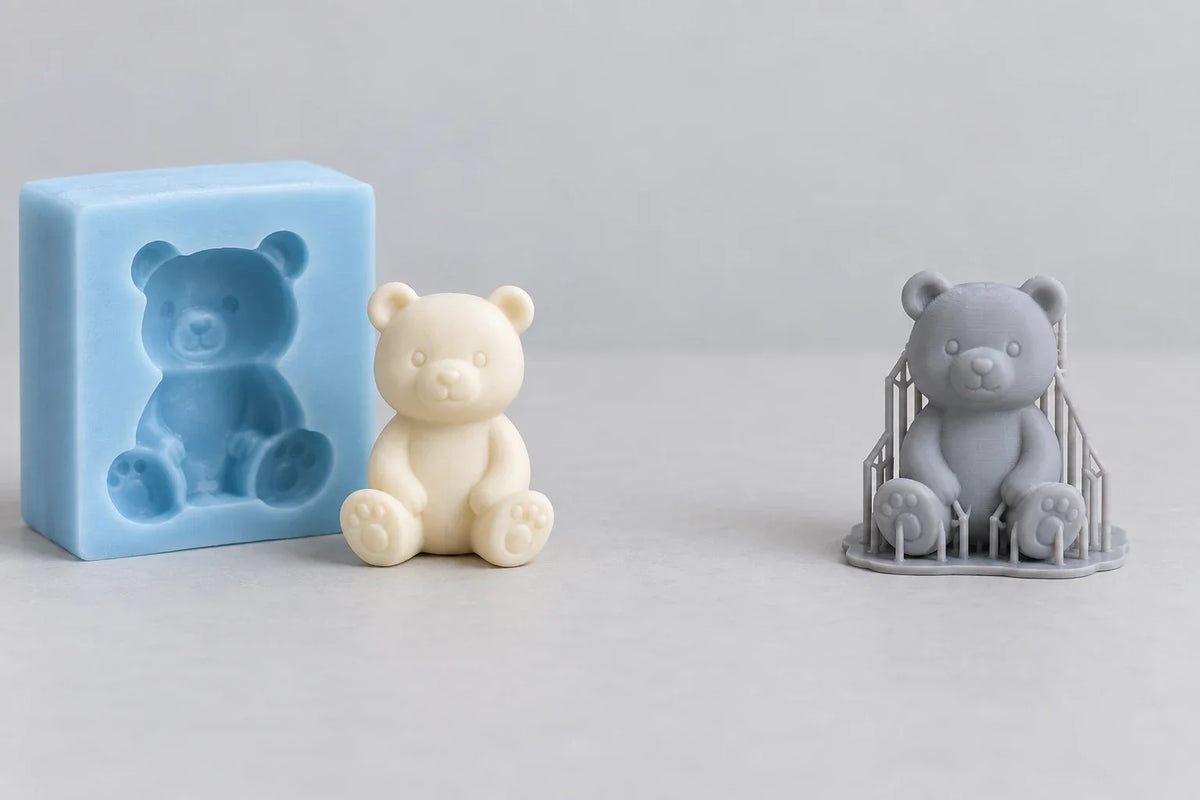 Conceptual cast bear and mold beside a resin printed bear with supports
